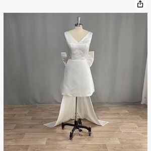 White dress with large bow in back. Size 16 new